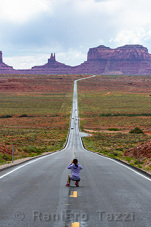 Tourist taking photo at Forrest Gump Point, Monument Valley, Utah